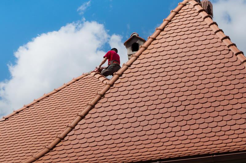 worker fixing the roof